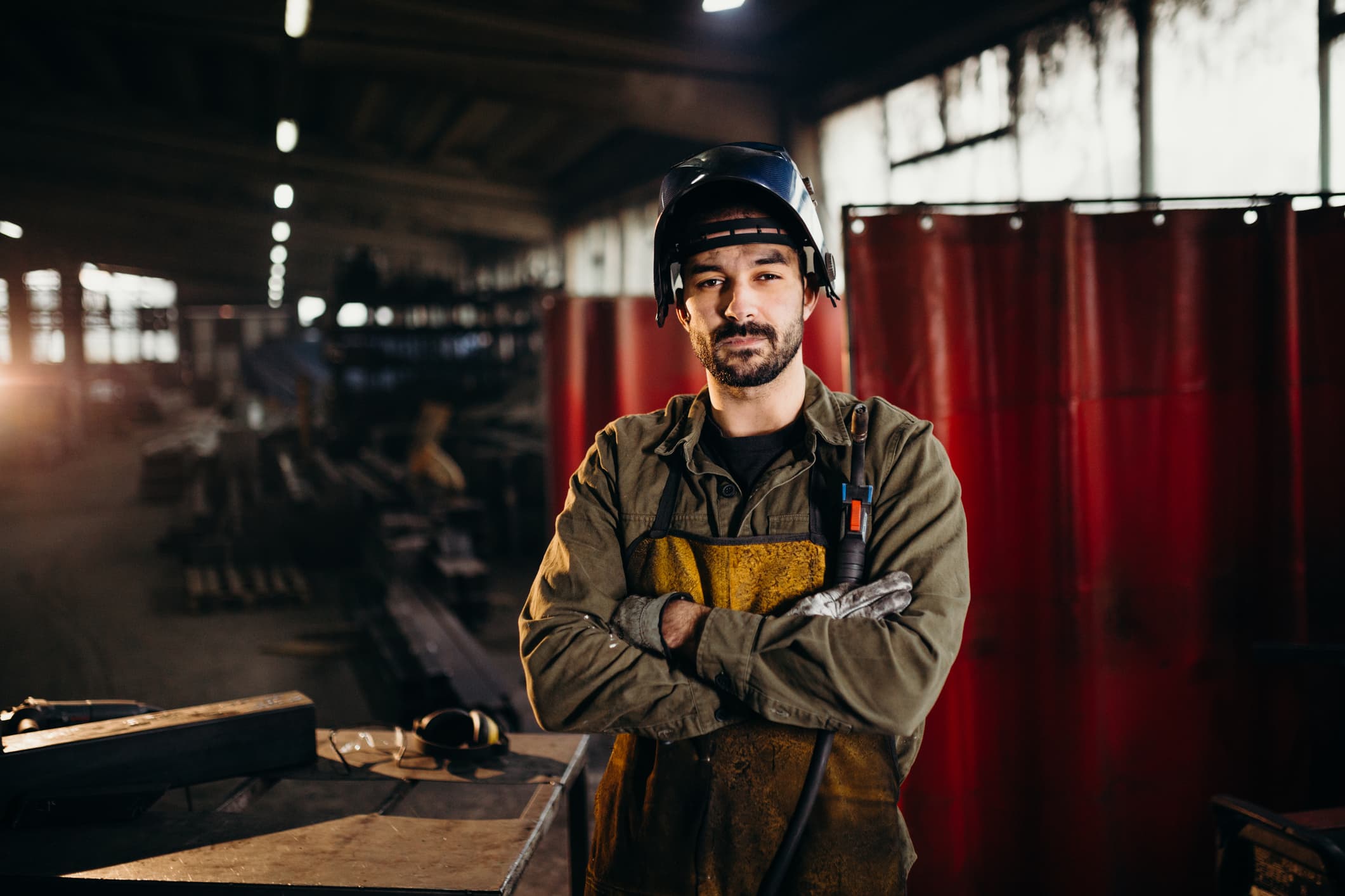 Male welder working in factory