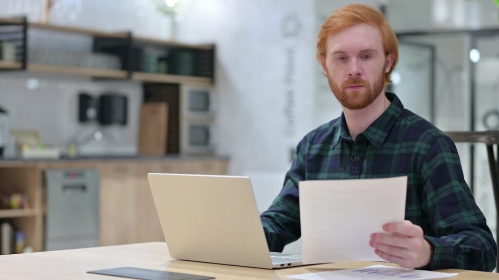 Man with laptop doing taxes